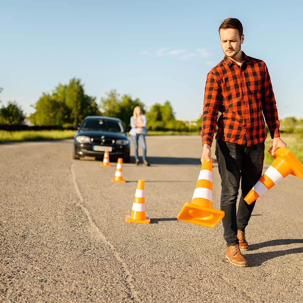 male-instructor-puts-cones-on-road-driving-school-8SHLHPT.jpg male-instructor-puts-cones-on-road-driving-school-8SHLHPT.jpg